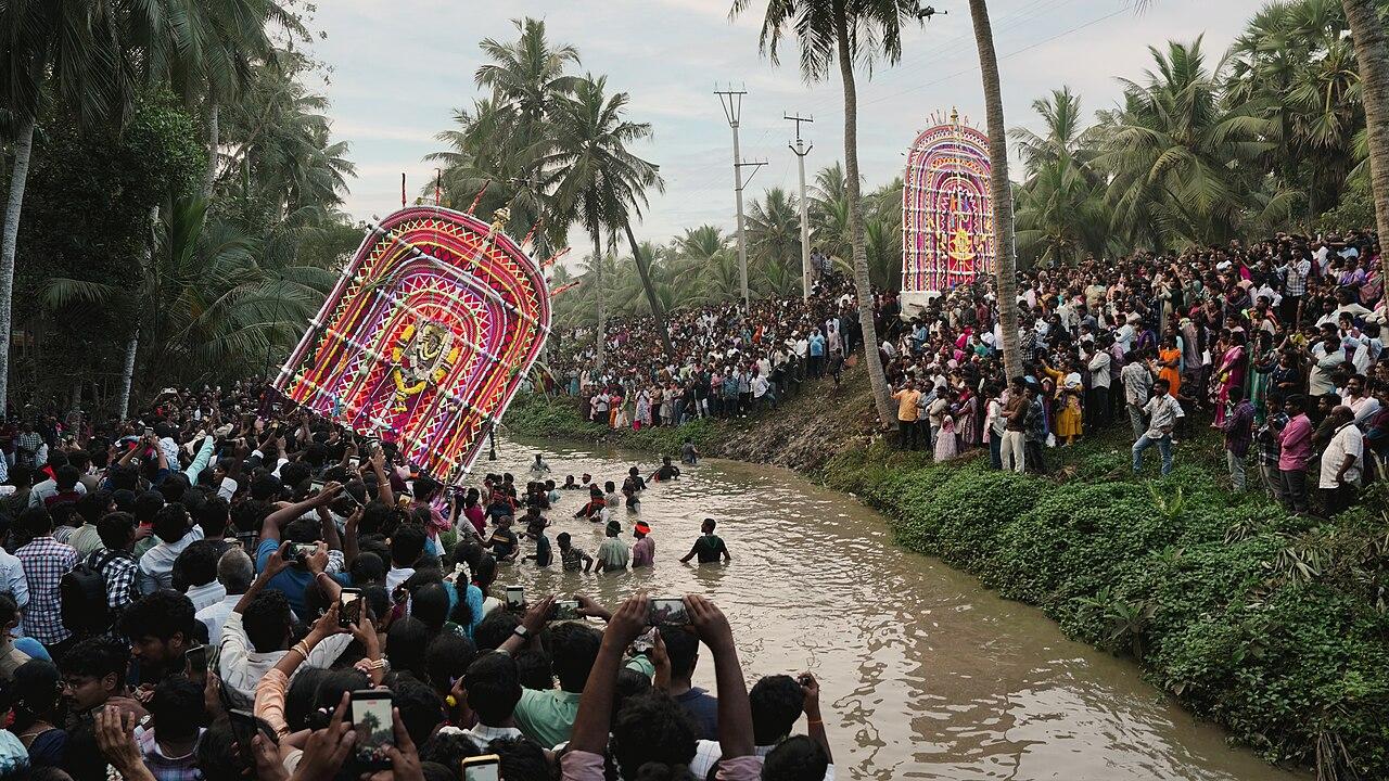 Coconut palms lining a Konaseema canal during the Sankranti Prabhala Theertham procession