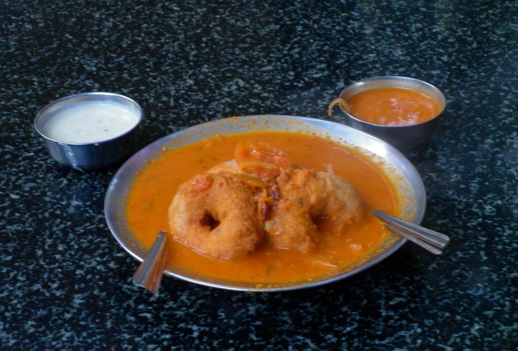 A South Indian breakfast of idli and vada served with sambar and chutney